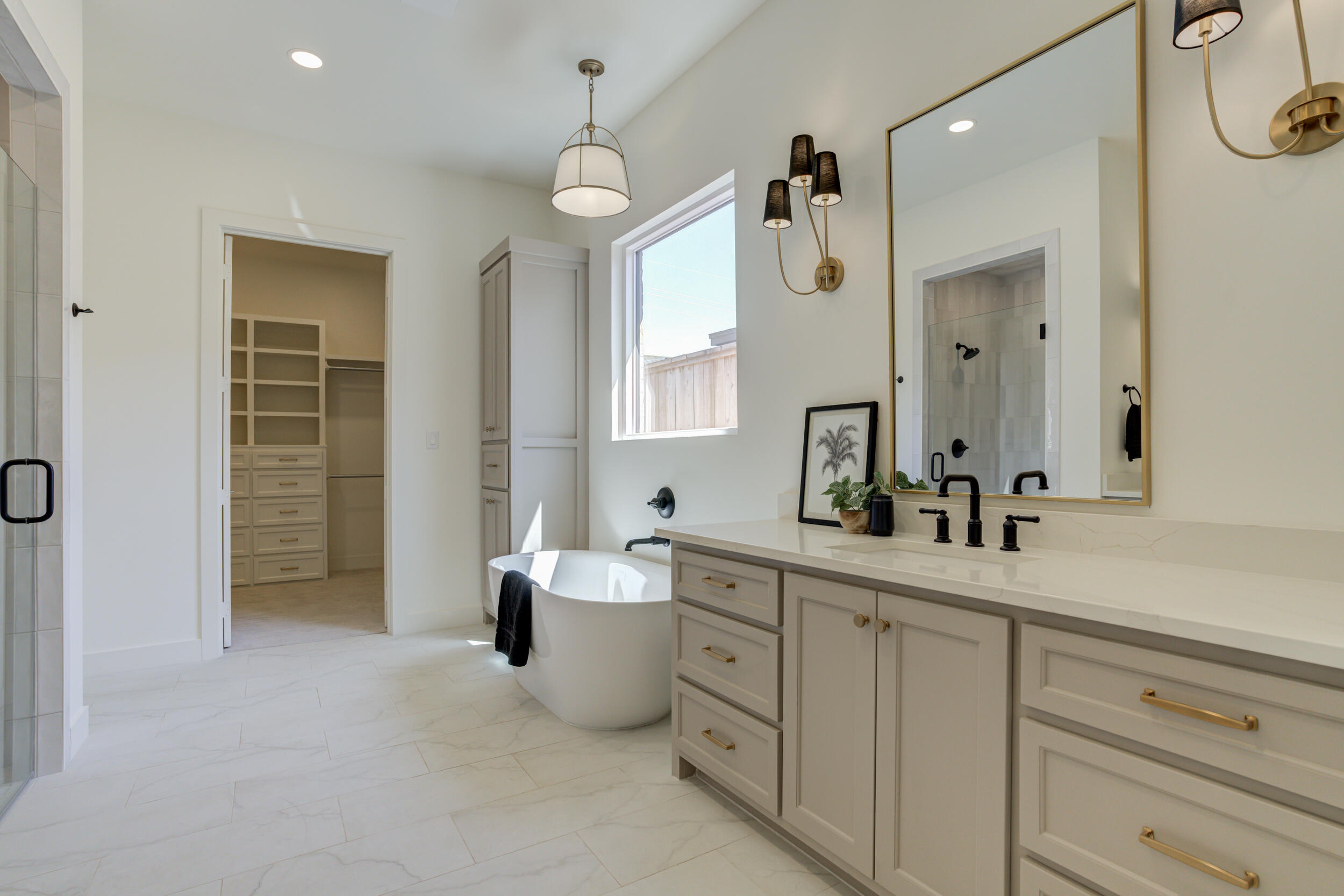 4610 138th Place Lubbock, TX 79424 - Photo 30 of 52 a spacious bathroom with a double vanity sink a mirror a bathtub and a window