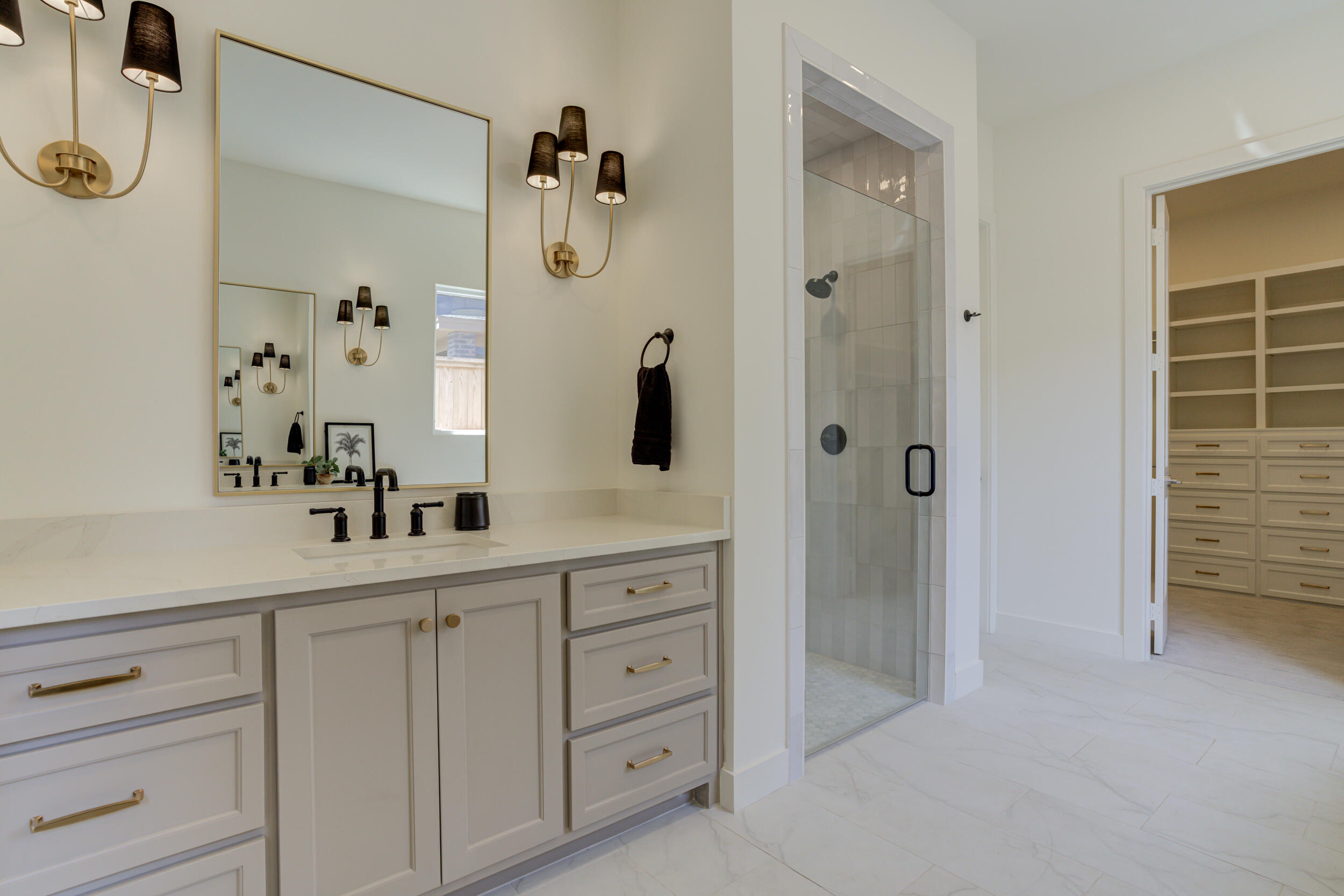4610 138th Place Lubbock, TX 79424 - Photo 31 of 52 a bathroom with a shower sink and mirror