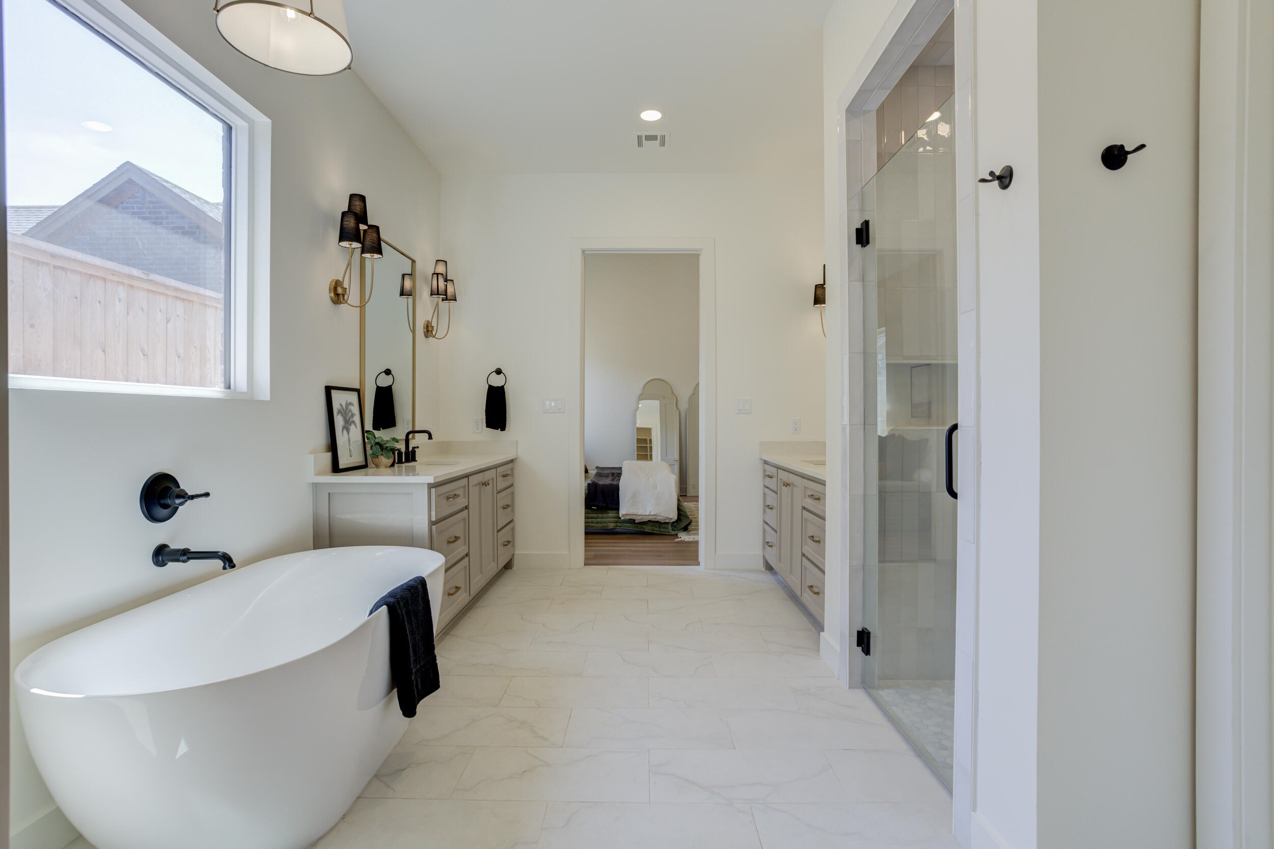 4610 138th Place Lubbock, TX 79424 - Photo 34 of 52 a bathroom with a tub sink and mirror
