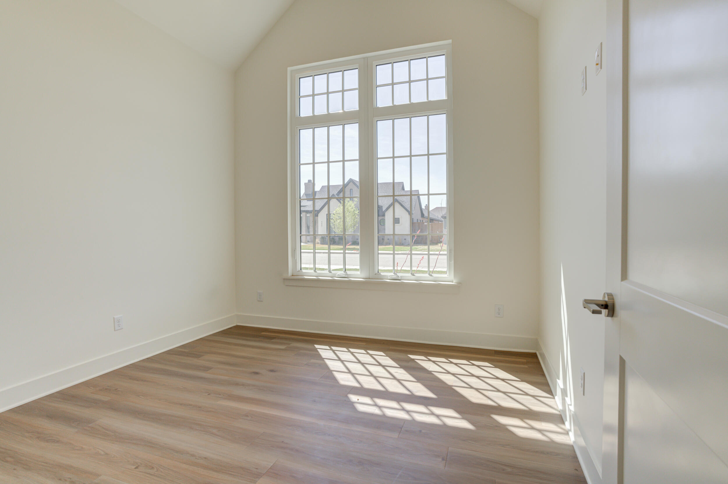 4610 138th Place Lubbock, TX 79424 - Photo 40 of 52 a view of an empty room with wooden floor and a window