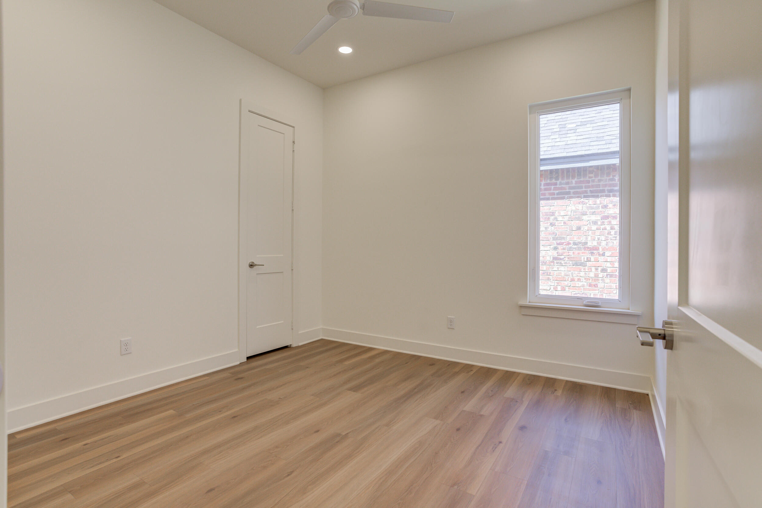 4610 138th Place Lubbock, TX 79424 - Photo 44 of 52 an empty room with wooden floor and windows