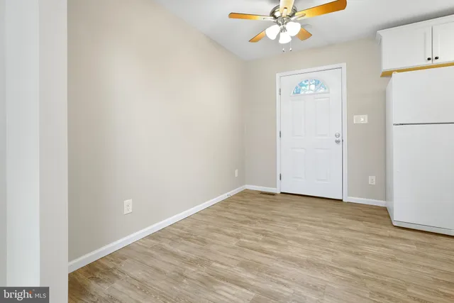 a view of an empty room with a ceiling fan