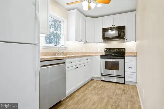 a kitchen with a stove a sink and a microwave