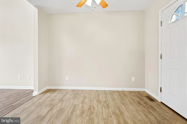 a view of an empty room and wooden floor