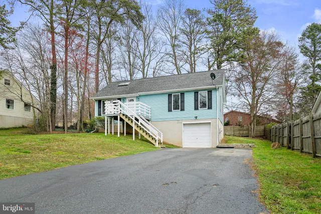 a view of a house with a yard and tree s