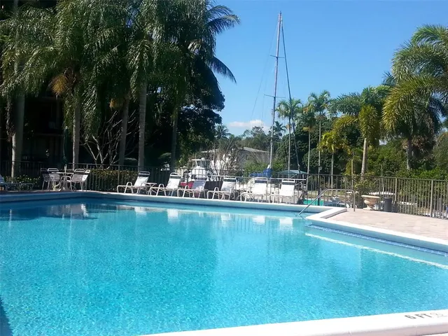 a view of a swimming pool with a table and chairs