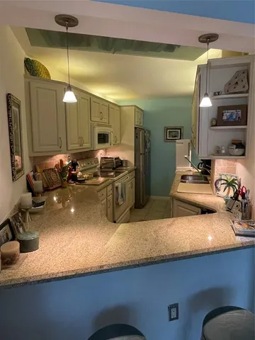 a kitchen with a sink and a refrigerator