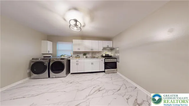 a kitchen with stainless steel appliances a refrigerator and a stove top oven
