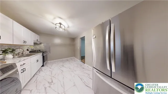 a kitchen with a stove top oven sink and cabinets