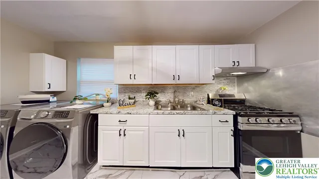 a kitchen with a stove top oven sink and cabinets