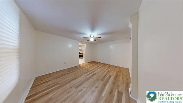 a view of empty room with wooden floor