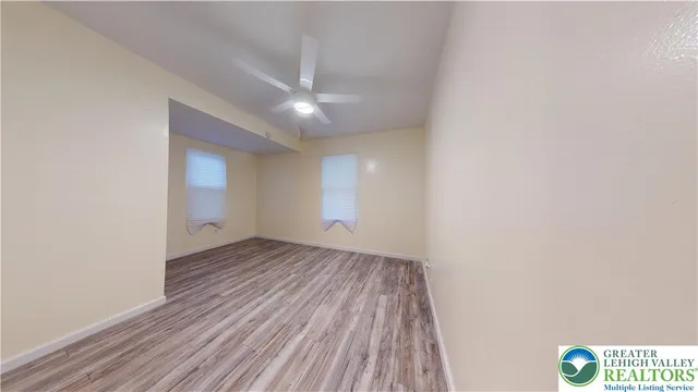 a view of room with window and hardwood floor