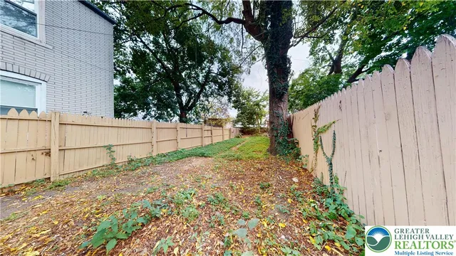 a view of a backyard with a tree