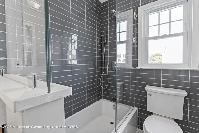 a white toilet sitting next to a bathroom sink