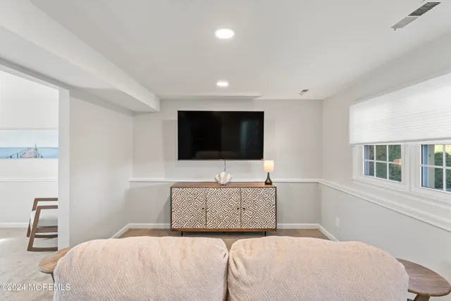 a living room with a flat screen tv and a couch