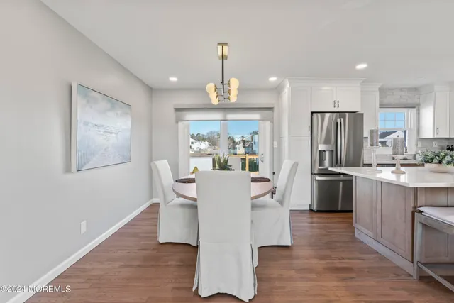 a view of kitchen with refrigerator and window