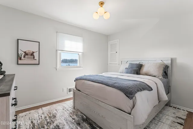 a bedroom with bed and a window