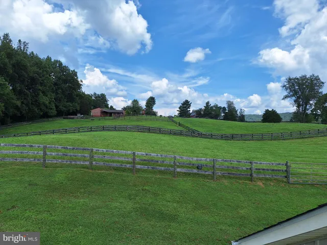 a view of grassy field with grass and trees