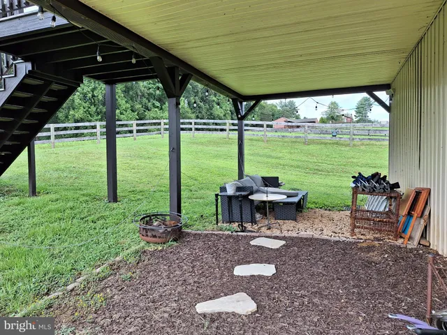 a view of a patio with a table chairs and a backyard