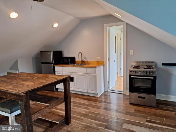 a kitchen with a stove a refrigerator and a stove top oven