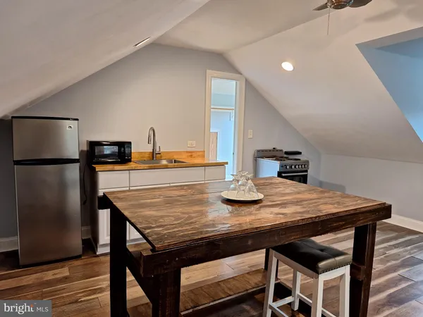 a dining table with chairs and refrigerator