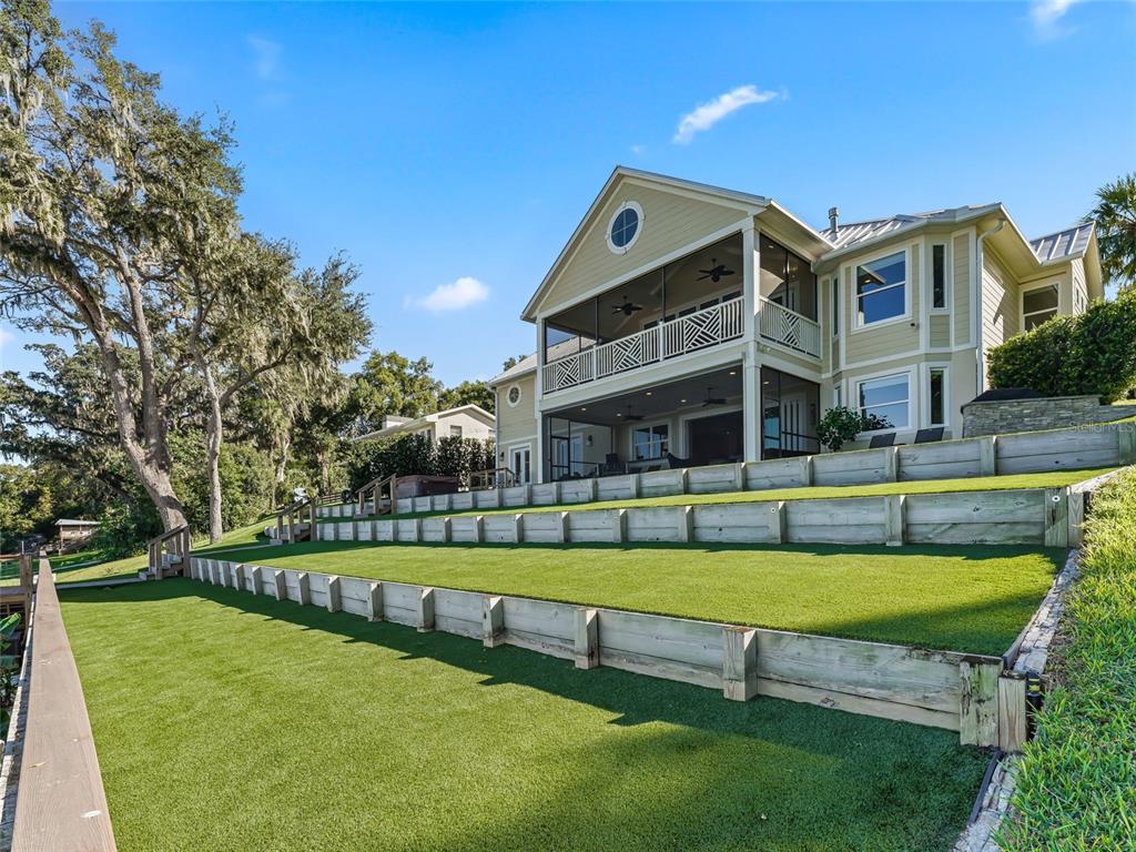 12943 Southeast Sunset Harbor Road Weirsdale, FL 32195 - Photo 87 of 87 a front view of a house with swimming pool and a yard