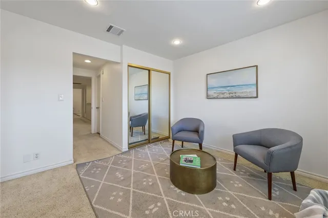 a living room with furniture a rug and a painting