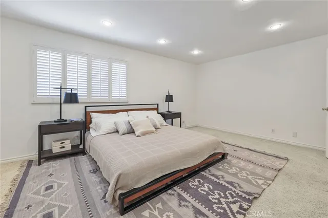 a bedroom with a bed and a night stand