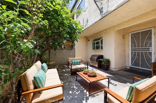 an outdoor living area with furniture