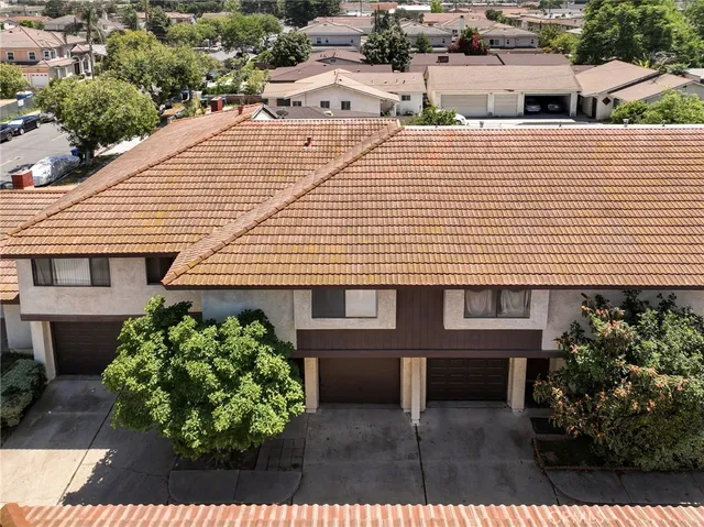 a aerial view of a house with a yard and potted plants