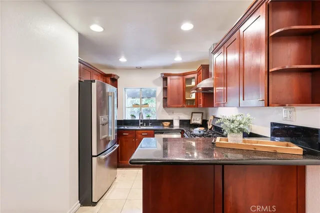 a kitchen with sink refrigerator and cabinets