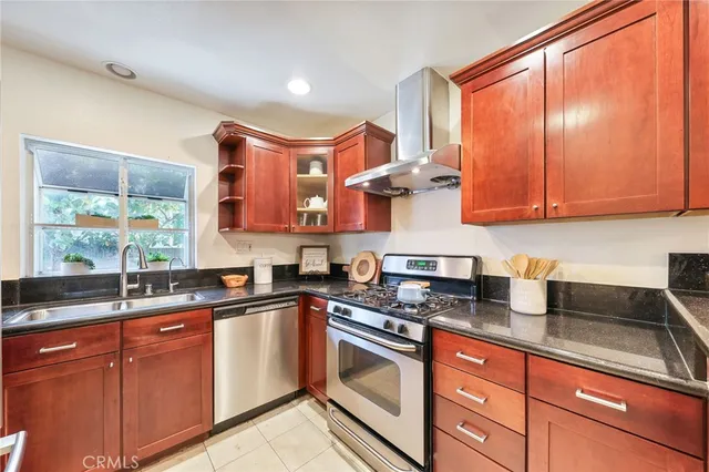 a kitchen with stainless steel appliances granite countertop a sink and a stove
