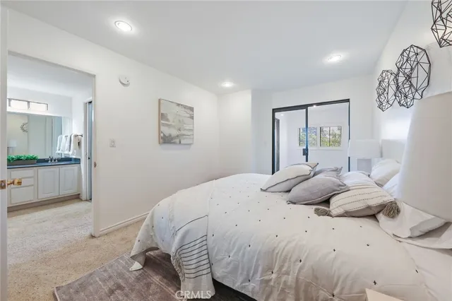 a bedroom with a large bed and a chandelier