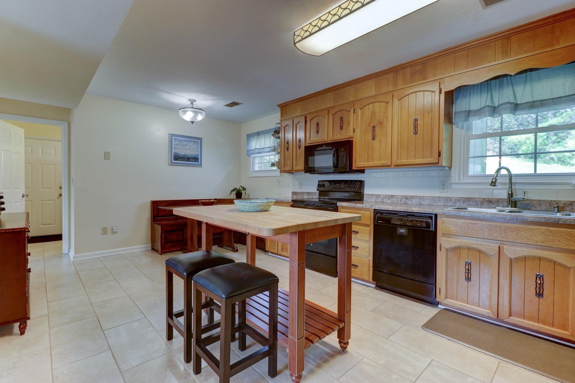 206 Ridgeview Road Blue Ridge, VA 24064 - Photo 14 of 44 a kitchen with stainless steel appliances granite countertop a stove a sink dishwasher and a microwave oven on the blue kitchen countertops