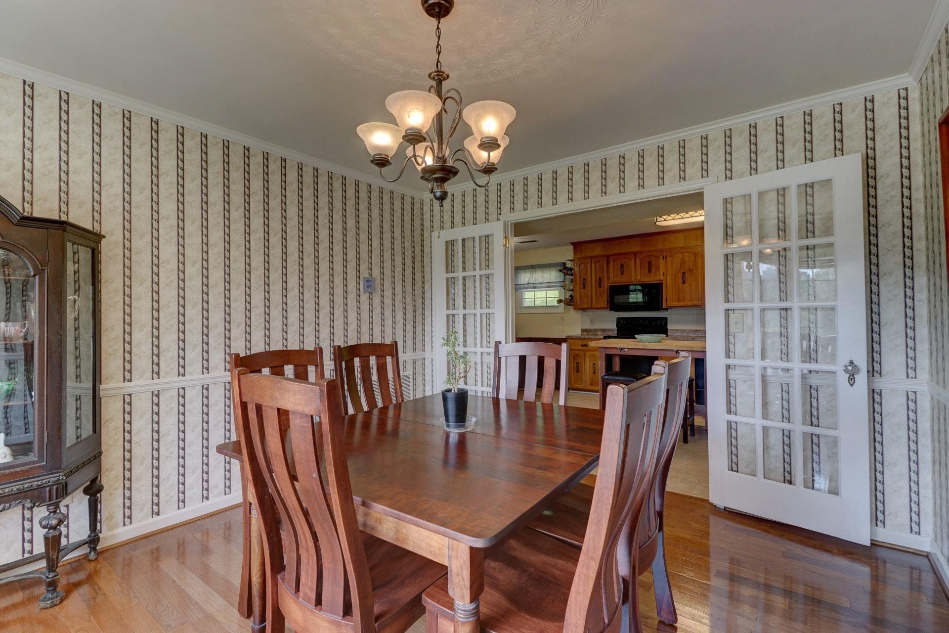 206 Ridgeview Road Blue Ridge, VA 24064 - Photo 9 of 44 a view of a dining room with furniture wooden floor and chandelier
