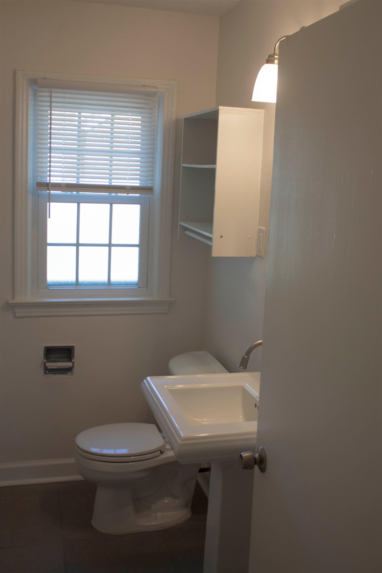 1058 Prescott Road Memphis, TN 38111 - Photo 11 of 16 a bathroom with a toilet a sink and mirror