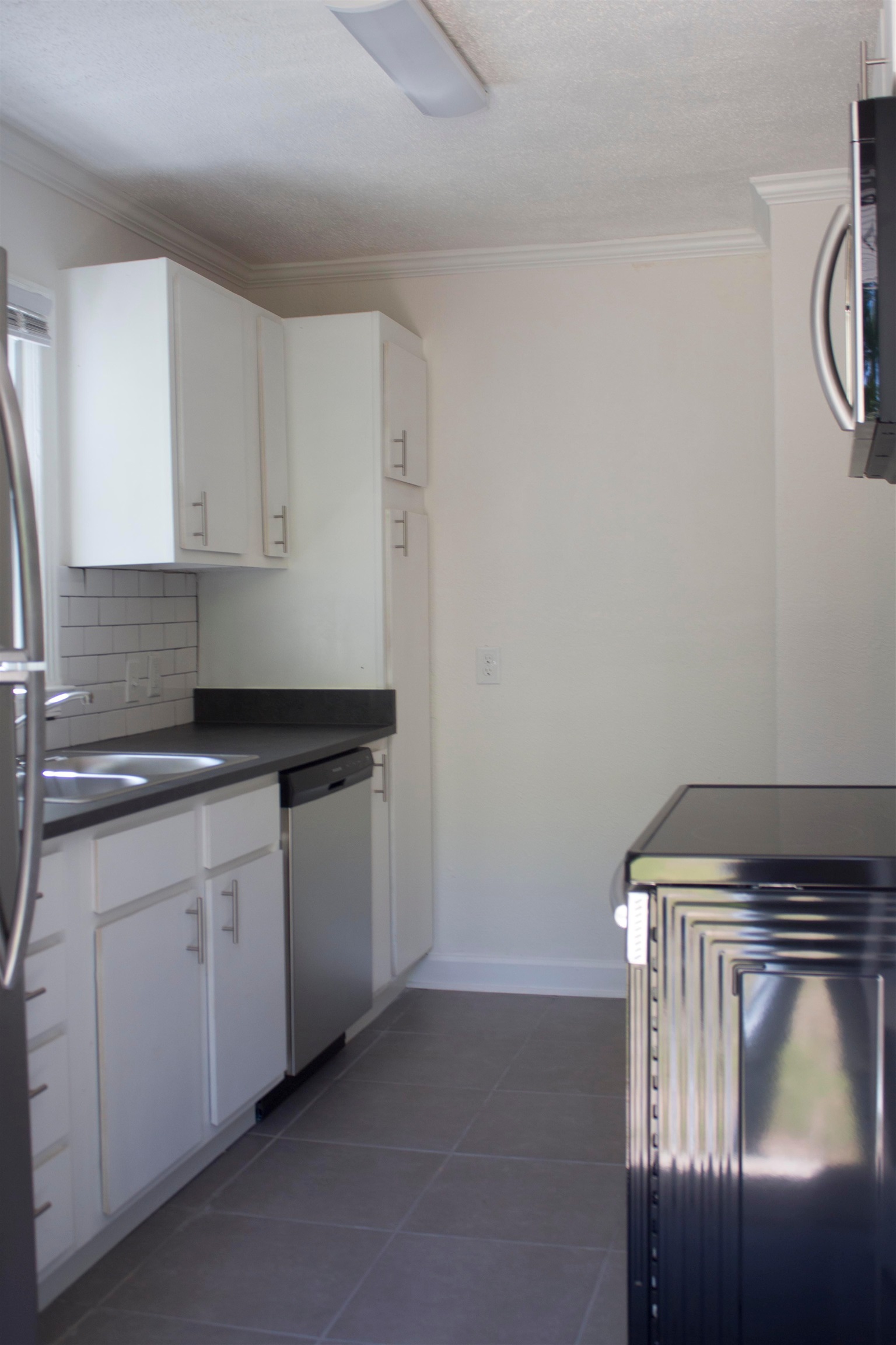 1058 Prescott Road Memphis, TN 38111 - Photo 6 of 16 a kitchen with a sink and cabinets