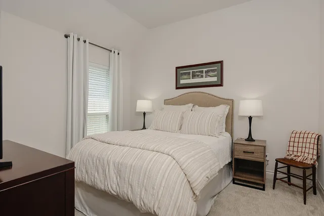 a bedroom with a bed and a desk