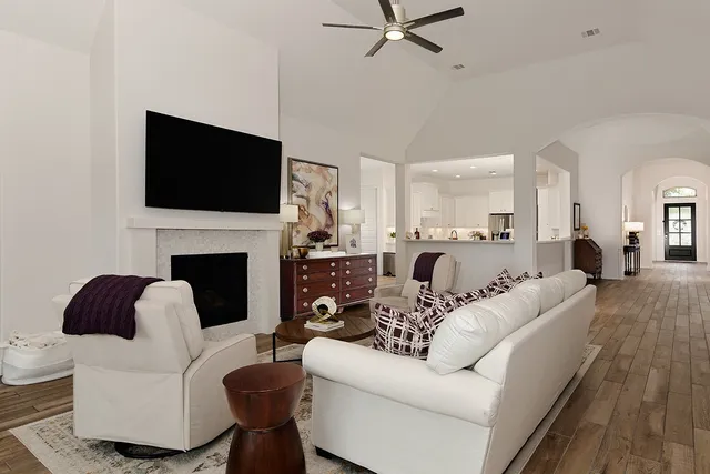 a living room with fireplace furniture and a flat screen tv