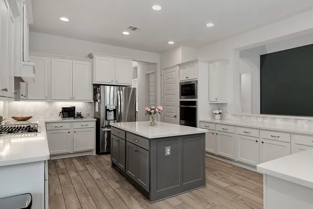a kitchen with a sink stove and refrigerator