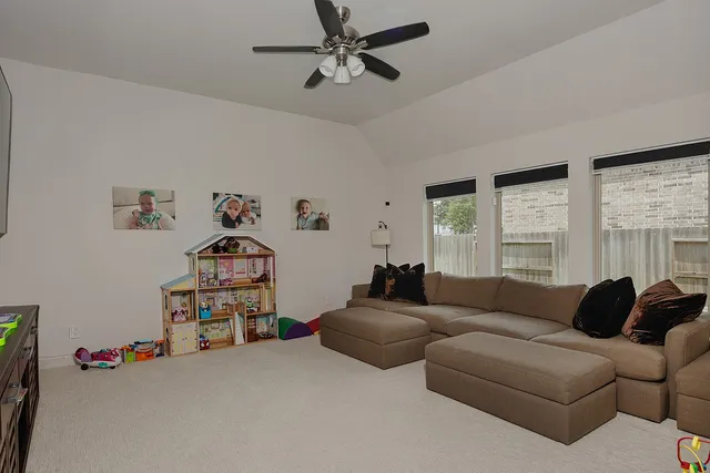 a living room with furniture cabinets and a window