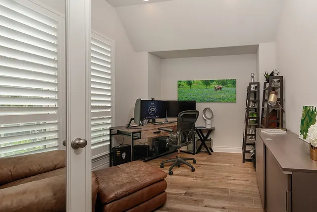 a view of a workspace with furniture and a window