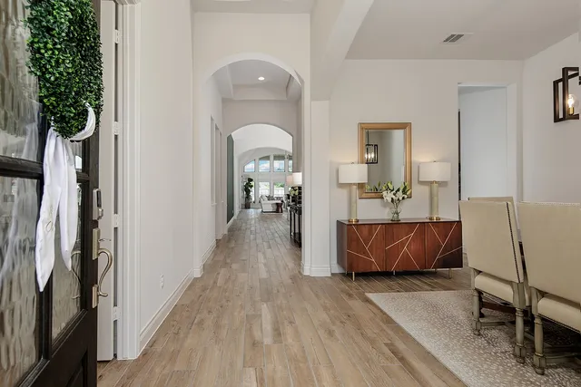 a living room with furniture and a potted plant