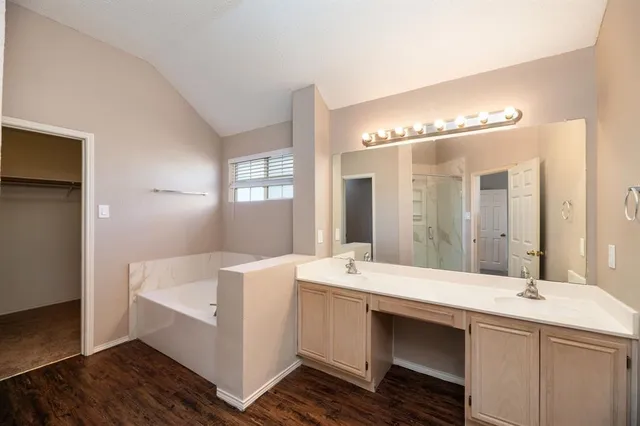 a bathroom with a double vanity sink and mirror