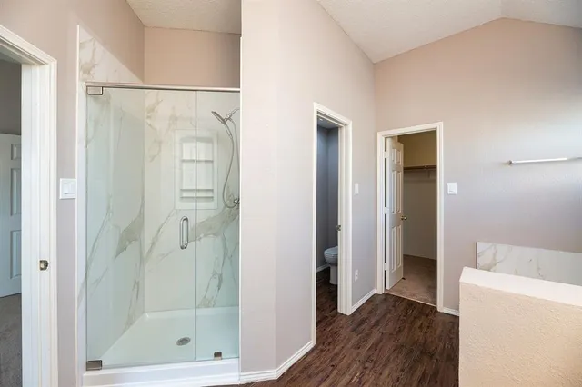 a bathroom with a shower and a bath tub