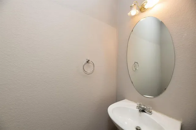 a bathroom with a sink and mirror