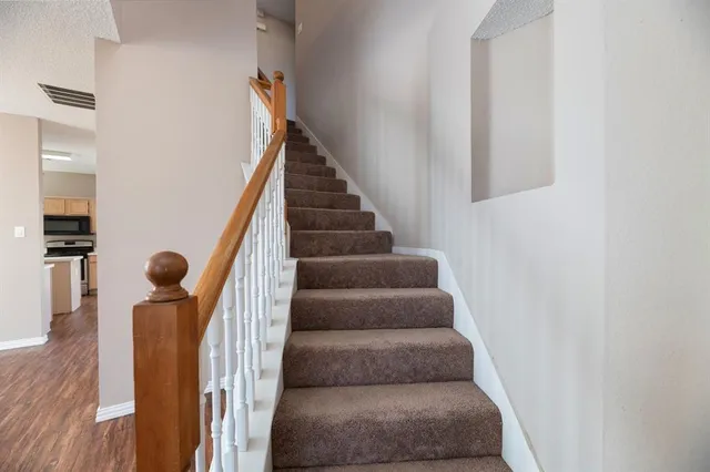 a view of staircase with white walls