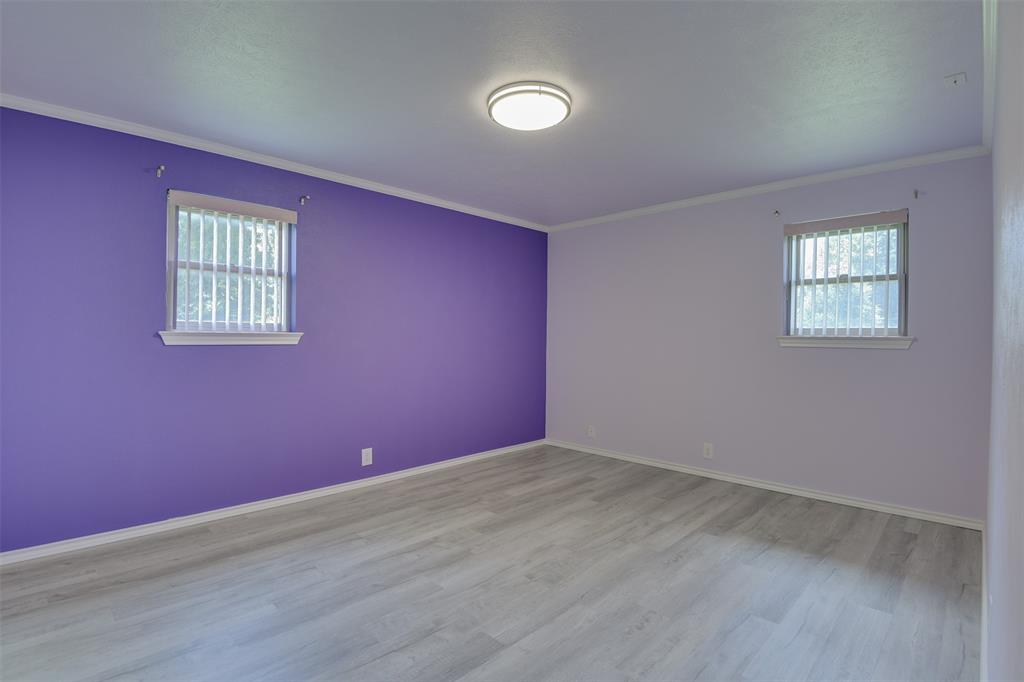 802 Cardinal Road Mansfield, TX 76063 - Photo 20 of 31 Empty room with ornamental molding and wood finished floors