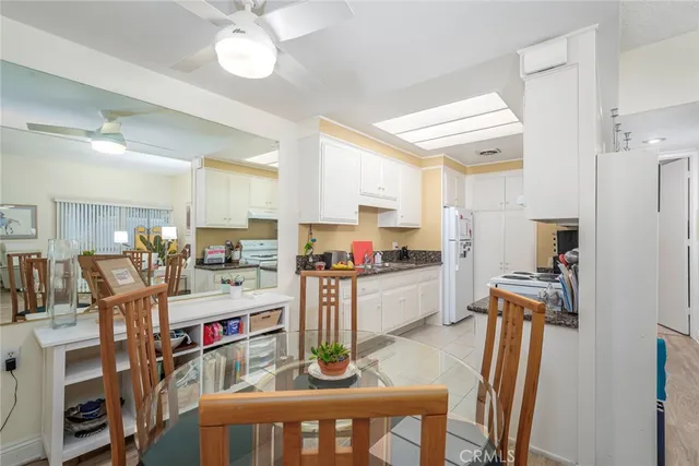 a kitchen with granite countertop cabinets and white appliances