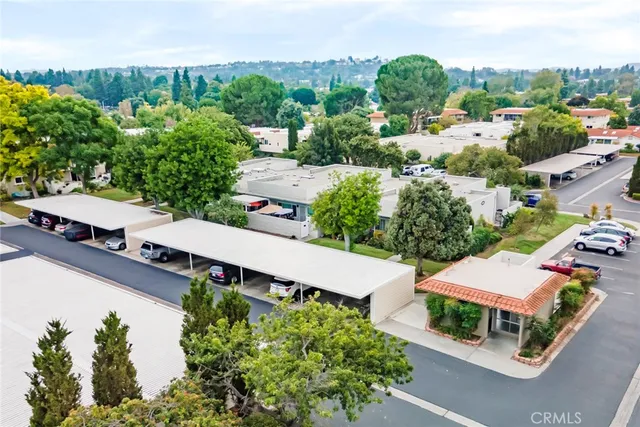 an aerial view of residential houses with city view